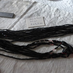 36 g of old Paris jet black tube beads on original threads