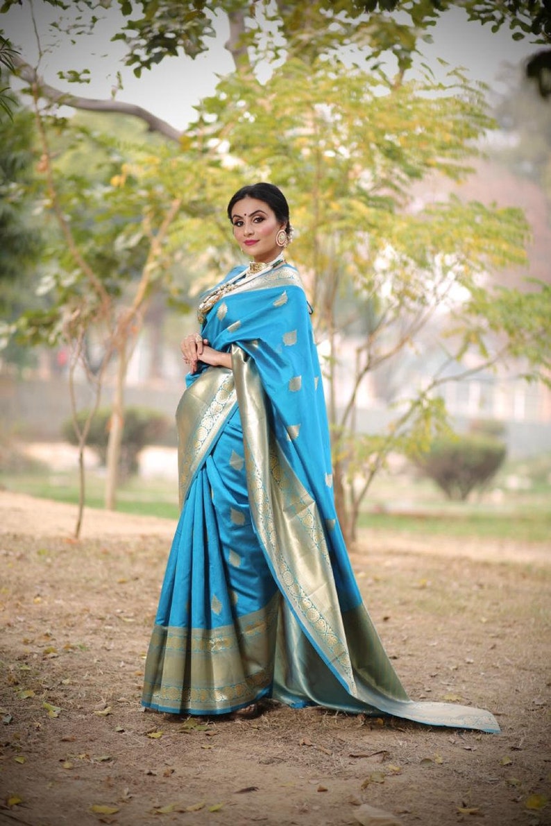 kanchipuram lichi silk saree gleams with gold zari floral buttas The sleek and elegant self zari floral brocade border beautifully