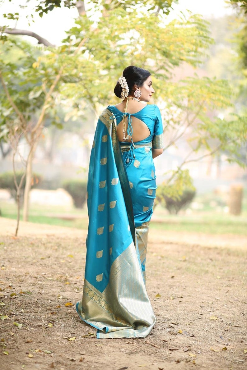 kanchipuram lichi silk saree gleams with gold zari floral buttas The sleek and elegant self zari floral brocade border beautifully