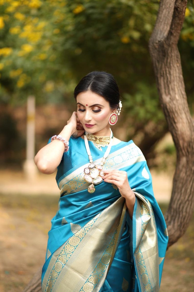 kanchipuram lichi silk saree gleams with gold zari floral buttas The sleek and elegant self zari floral brocade border beautifully