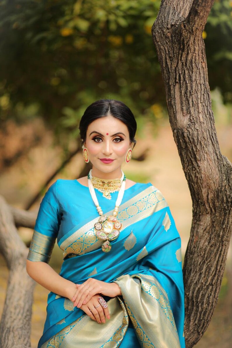 kanchipuram lichi silk saree gleams with gold zari floral buttas The sleek and elegant self zari floral brocade border beautifully