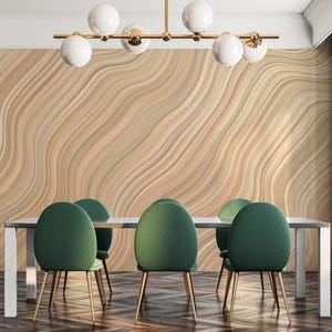 May include: A modern dining room featuring a light wood-paneled wall with a wave pattern. A rectangular table with a white base and a gray top is surrounded by six green chairs with gold legs. A chandelier with white globe lights hangs above.