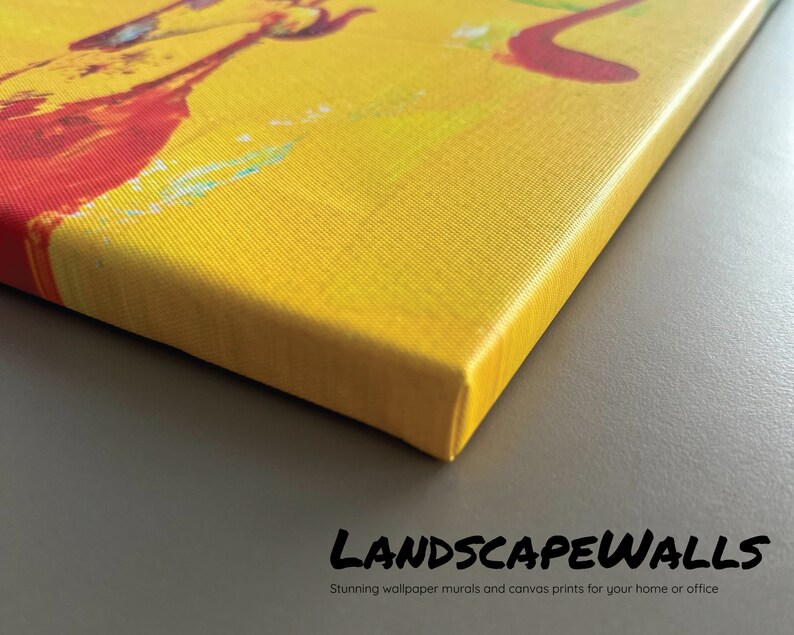 May include: Close-up of a canvas print with a vibrant abstract design in yellow, red, and blue hues. The canvas is stretched over a wooden frame. The text "LANDSCAPEWALLS" and "Stunning wallpaper murals and canvas prints for your home or office" are visible.