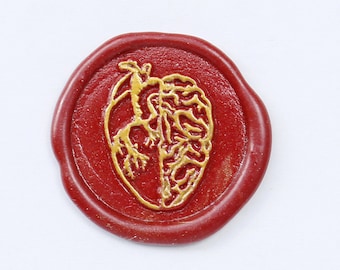 May include: A red wax seal with a gold heart and brain design. The seal is on a white background.