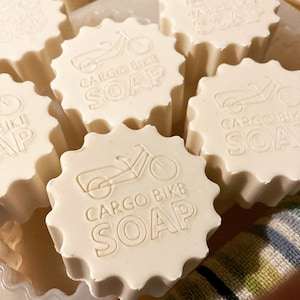May include: Five white, star-shaped soaps with the text "CARGO BIKE SOAP" and a bicycle graphic.