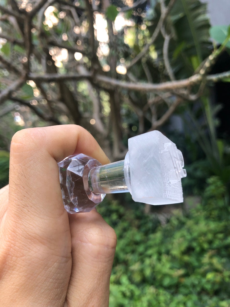May include: A clear glass bottle stopper with a faceted top and a clear plastic insert. The stopper is designed to fit a bottle of wine or other beverage.
