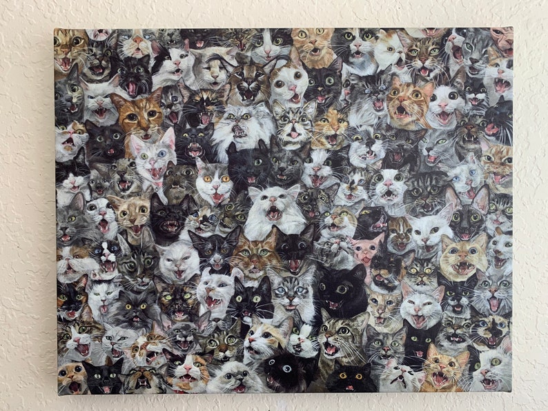 May include: A canvas print featuring a multitude of cat faces, each with a unique expression. The cats vary in color, including black, white, gray, and tabby patterns. The artwork creates a dense, textured appearance with a variety of open mouths and visible teeth.