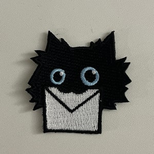 May include: A set of three ceramic mugs with a speckled, matte finish in cream, light grey, and dark grey. Each mug has a simple, minimalist design, suitable for coffee or tea.