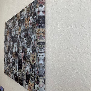 May include: A canvas print featuring a collage of numerous cat faces, each with a unique expression. The cats' fur colors vary, including black, white, gray, and tabby patterns. The artwork is mounted on a wooden frame and displayed on a white wall.