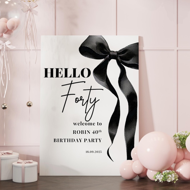 May include: A white sign with black text and a black bow. The text reads "HELLO Forty welcome to ROBIN 40th BIRTHDAY PARTY 18.09.2025".