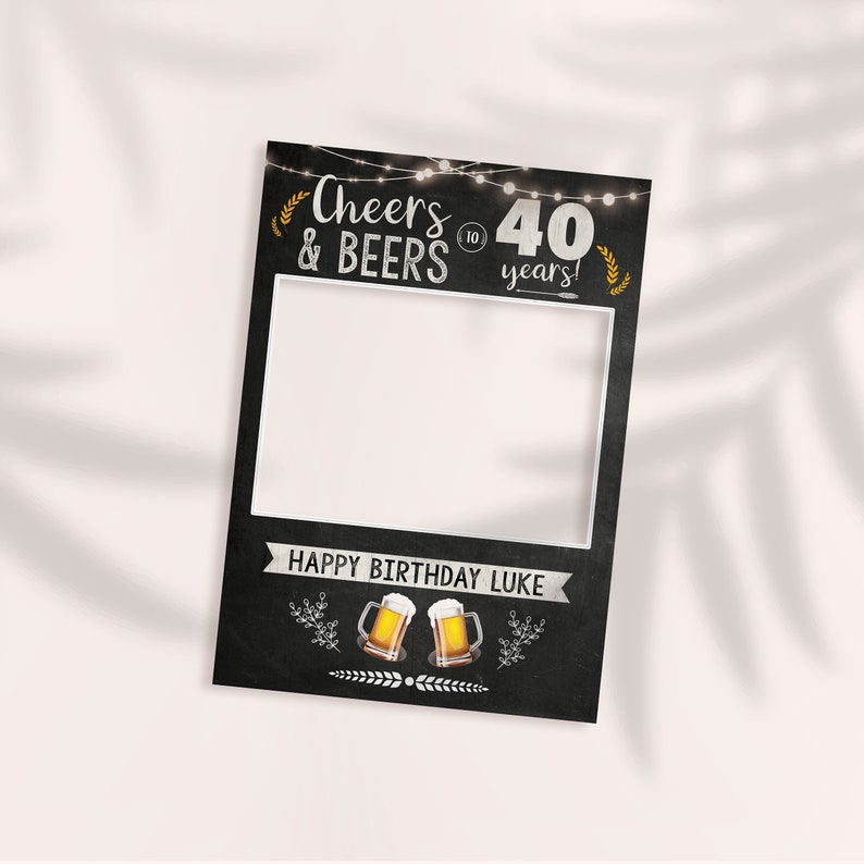 May include: A black chalkboard photo booth prop with the text "Cheers & Beers to 40 years!" and a space for a photo. The bottom of the prop says "Happy Birthday Luke" and has two illustrations of beer mugs.