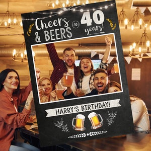 May include: Black and white photo booth sign with the text "Cheers & Beers to 40 years!" and a space for a photo. The sign also has the text "Harry's Birthday!" and two beer mugs with the text "40" on them.