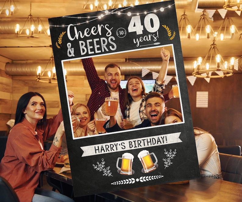 May include: Black and white photo booth sign with the text "Cheers & Beers to 40 years!" and a space for a photo. The sign also has the text "Harry's Birthday!" and two beer mugs with the text "40" on them.