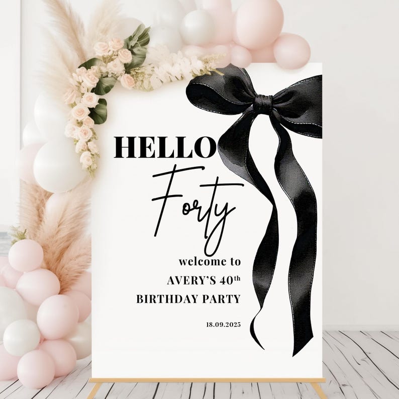 May include: A white sign with black text and a black ribbon bow. The text reads "HELLO Forty" and "welcome to AVERY'S 40th BIRTHDAY PARTY 18.09.2025".