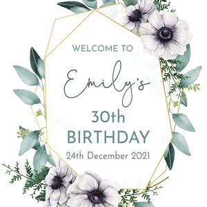 May include: A white and gold geometric frame with green eucalyptus leaves and white anemones. The text "Welcome to Emily's 30th Birthday 24th December 2021" is inside the frame.