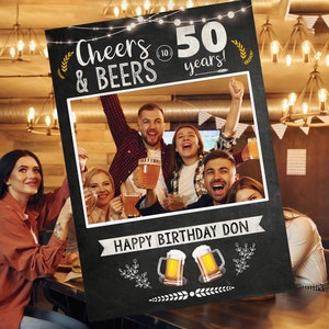 May include: Blackboard photo booth prop with the text "Cheers & Beers to 50 years!" and a space for a photo. The photo booth prop also has a happy birthday message and two beer mugs.