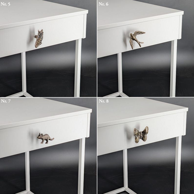 May include: Four white bedside tables with decorative drawer pulls. The pulls are shaped like an owl, a bird, a dinosaur, and a butterfly. The tables have white metal legs.