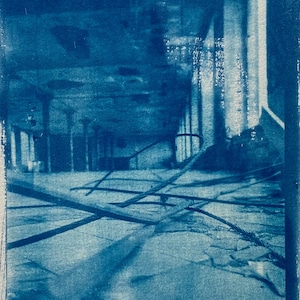 May include: A cyanotype print of an interior space, possibly a building, with architectural elements and debris. The image is framed with a dark blue border. The word "-forst-" is written at the bottom, along with the initials "EA" and "SSB'22".