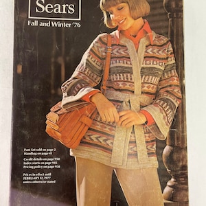 May include: A Sears catalog cover from Fall and Winter 1976 featuring a woman wearing a brown and white patterned sweater with a brown leather handbag. The text on the cover reads "Sears Fall and Winter '76".