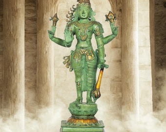 May include: A green statue of a deity with multiple arms, adorned with gold accents. The statue stands on a pedestal with a gold base, set against a backdrop of arched columns. The statue holds various objects and wears a crown.