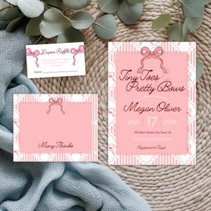 May include: A set of pink and white baby shower stationery including an invitation, a thank you card, and a diaper raffle ticket. Each piece features a scalloped border, a pink bow illustration, and striped patterns with printed text details.