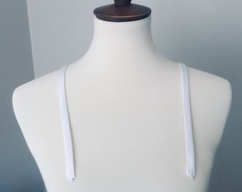 Detachable straps.   White 1/2 inch wide soft satin straps.