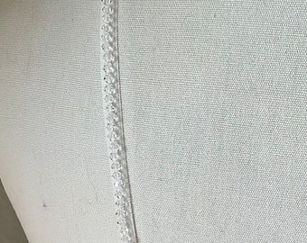 Detachable straps. 4mm crystals ( smaller ) beaded onto off white organza spaghetti straps