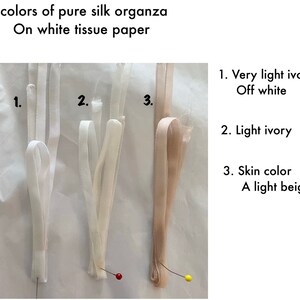 May include: Three samples of pure silk organza fabric in different shades of ivory, displayed on white tissue paper. The fabric is labeled 1. Very light ivory Off white, 2. Light ivory, and 3. Skin color A light beige.