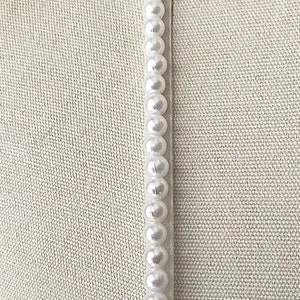 Detachable straps.  6mm Pearls beaded onto organza spaghetti straps