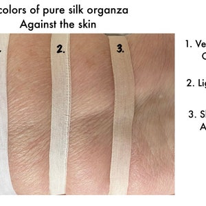 May include: Three swatches of pure silk organza fabric in different shades of ivory and beige. The swatches are labeled 1, 2, and 3.  1. Very light ivory. Off - white. 2. Light ivory. 3. Skin color. A light beige.