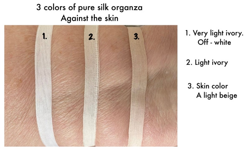 May include: Three swatches of pure silk organza fabric in different shades of ivory and beige. The swatches are labeled 1, 2, and 3.  1. Very light ivory. Off - white. 2. Light ivory. 3. Skin color. A light beige.