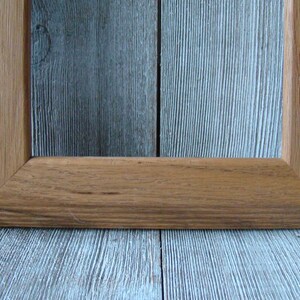 May include: A simple, rectangular wooden picture frame with a natural wood finish.
