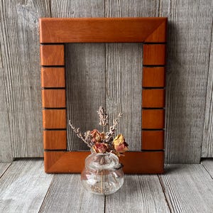 May include: A set of three ceramic mugs with a speckled, matte finish. Each mug features a different color: light blue, cream, and gray. The mugs have a simple, modern design with a rounded shape and a handle.