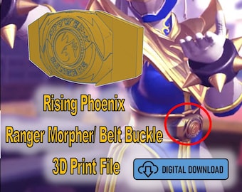 May include: A 3D printed model of a gold and blue Power Rangers belt buckle. The buckle features a phoenix design and the words "Rising Phoenix Ranger Morpher/Belt Buckle 3D Print File".