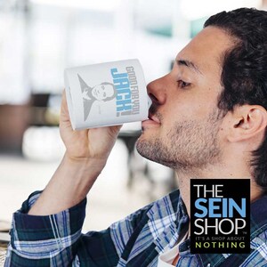May include: White ceramic mug with a blue and black image of a man with the text "Good for you Jack!" printed on it. The mug is being held by a person wearing a plaid shirt. The text "The Sein Shop" is printed in white on a black background with the text "It's a shop about nothing" printed below it in white.