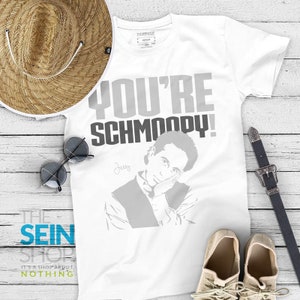 May include: White t-shirt with a gray and black graphic of Jerry Seinfeld with the text "You're Schmoopy!" and the signature "Jerry".