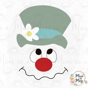 May include: A snowman face with a green top hat, a white flower, and a blue ribbon. The snowman has black eyes, a red nose, and a black mouth.