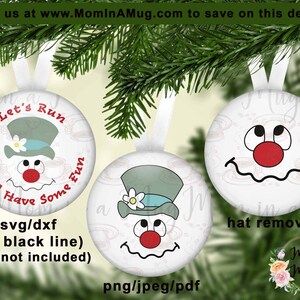 May include: Two white round Christmas baubles featuring a snowman design. The snowman has a red nose, black eyes, and a black mouth. The bauble on the left has a blue and white hat with a white flower on top. The bauble on the right has the hat removed. The text "Let's Run We'll Have Some Fun" is on the bauble on the left. The text "hat removed" is below the bauble on the right.