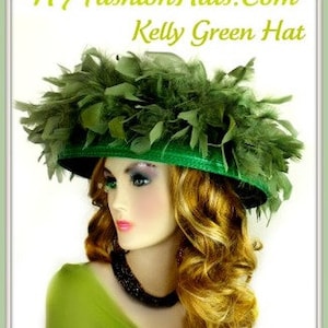 May include: A kelly green hat with a wide brim and a large green feather trim. The hat is worn by a mannequin with long blonde hair.