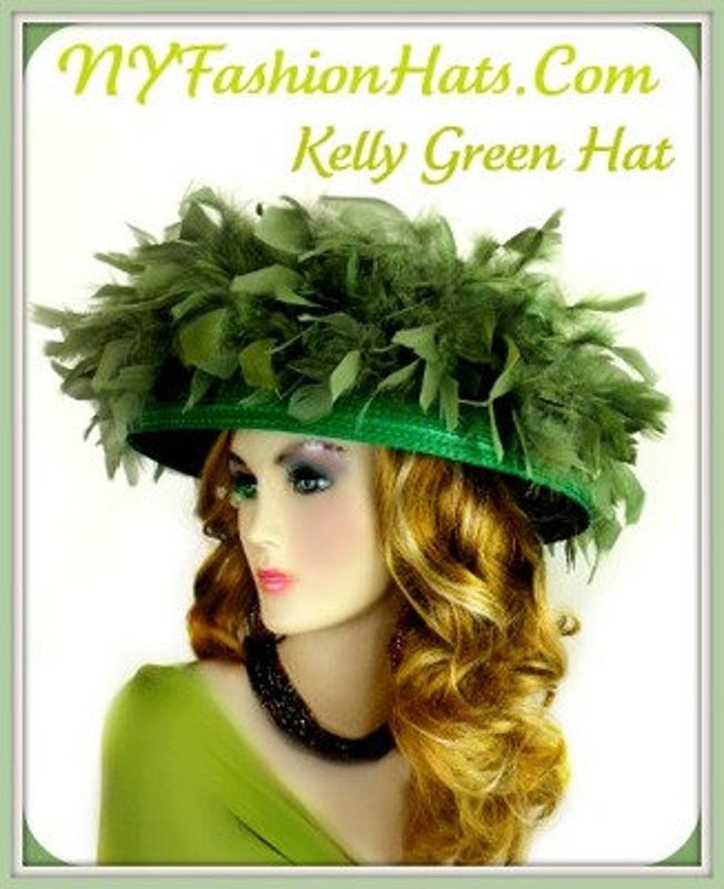 May include: A kelly green hat with a wide brim and a large green feather trim. The hat is worn by a mannequin with long blonde hair.