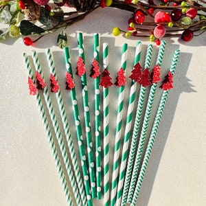 May include: A set of 12 green and white striped paper straws with red glitter Christmas tree toppers. The straws have different patterns, including polka dots, stripes, and chevron.