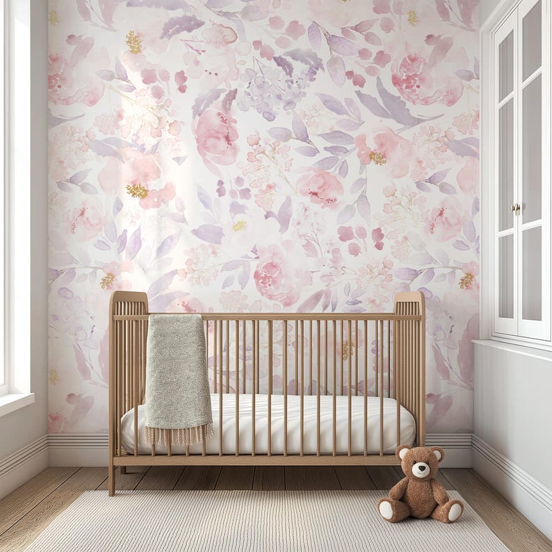 May include: A nursery with a wooden crib, a soft blanket, and a teddy bear on a light-colored rug. The wall is adorned with a floral wallpaper in shades of pink, purple, and white, creating a serene and inviting atmosphere.