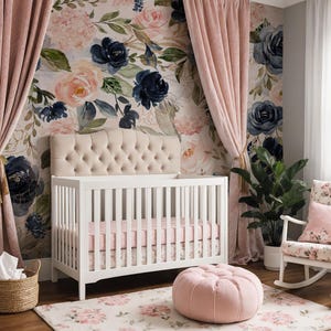 May include: A white crib with a tufted beige headboard, a pink sheet, and a floral skirt. The room features floral wallpaper, pink velvet curtains, a pink tufted ottoman, a white rocking chair with a floral cushion, and a woven basket with white fabric.