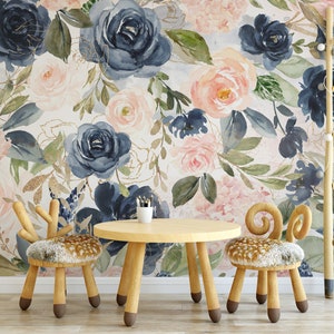 May include: A children's room scene featuring a floral wallpaper with navy, blush, and gold accents. A small wooden table and two chairs with deer-inspired designs are in front of the wallpaper. A wooden ladder and shelf add to the decor.