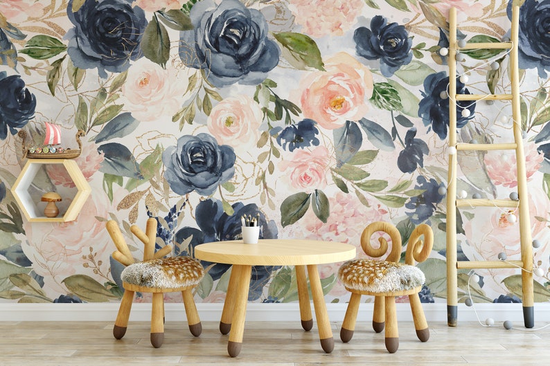 May include: A children's room scene featuring a floral wallpaper with navy, blush, and gold accents. A small wooden table and two chairs with deer-inspired designs are in front of the wallpaper. A wooden ladder and shelf add to the decor.