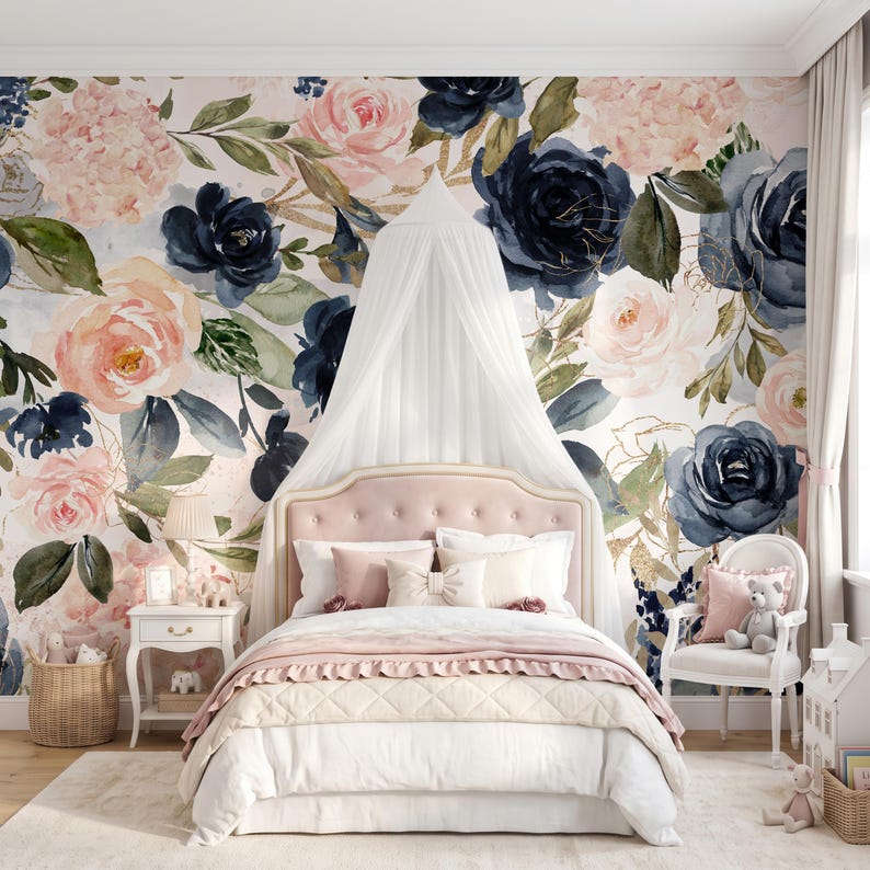 May include: A bedroom featuring a bed with a tufted pink headboard, white bedding, and a white canopy. The wall behind the bed is covered in wallpaper with a large-scale watercolor floral pattern in shades of navy blue, blush pink, and green.