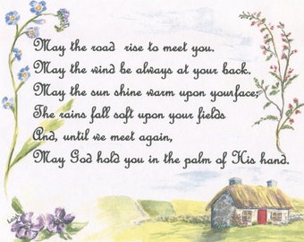 May include: Watercolor painting with a countryside scene and a traditional Irish cottage. The text reads "May the road rise to meet you." Floral accents frame the text. The cottage has a red door.