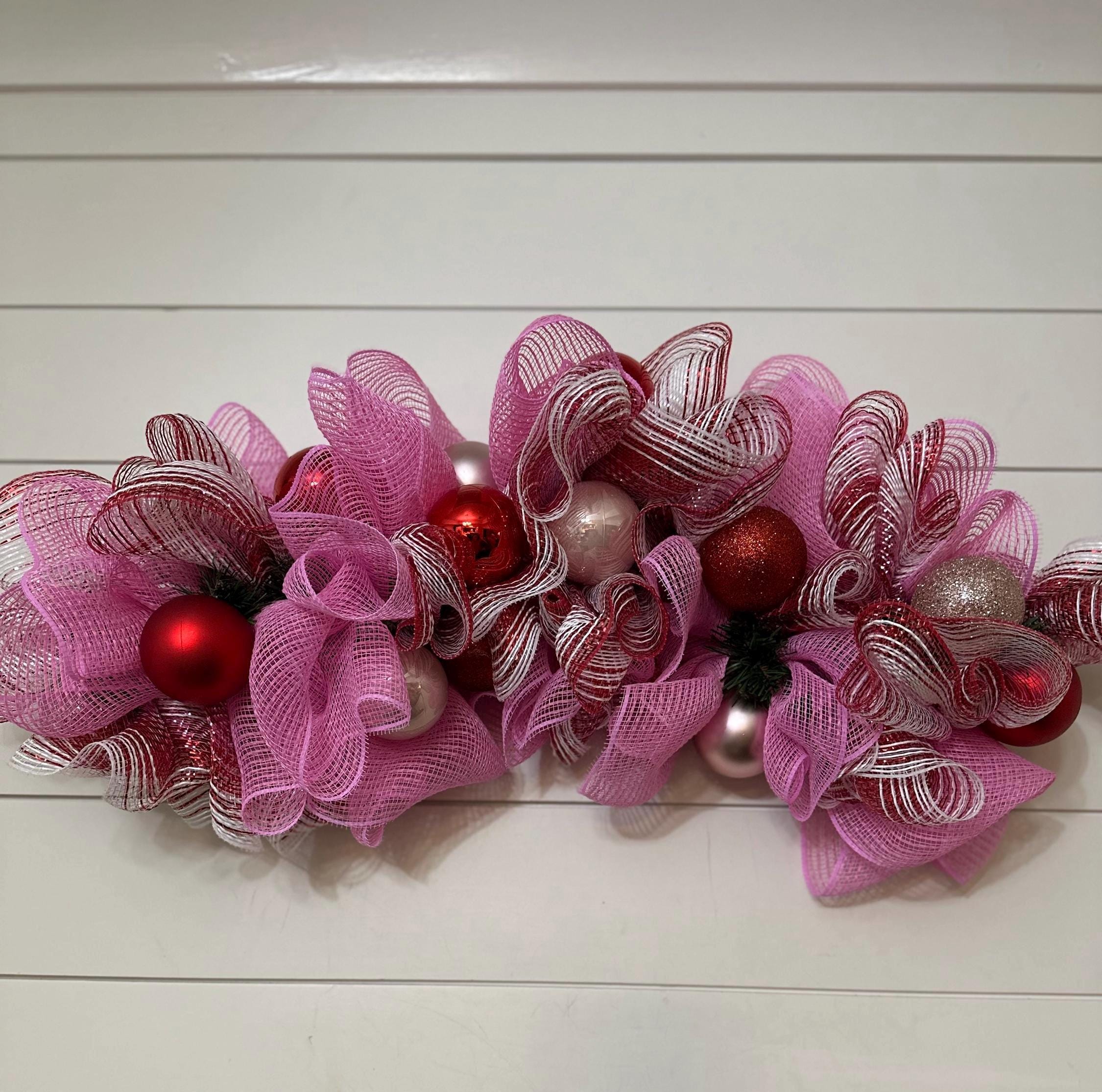 Pink and red Christmas garland with ornaments, horizontal wall swag,…
