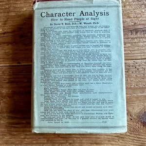May include: A vintage book cover with a blue background and white text. The title is "Character Analysis: How to Read People at Sight" by David V. Bush, D.D. - W. Waugh, Ph.D. The book cover also includes a description of the book's contents, including information about how to understand people's personalities and how to use this knowledge to improve your life.