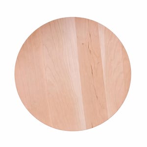 May include: A round, light-colored wooden cutting board. The board has a natural wood grain pattern and is made of a light brown wood. The board is circular and appears to be new.